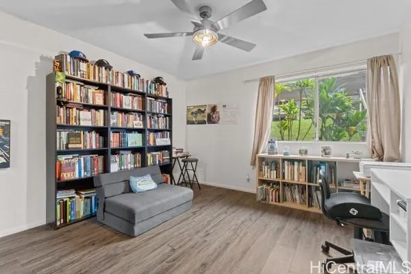 a living room with furniture and a book shelf