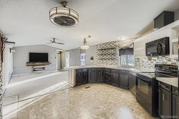 a kitchen with stainless steel appliances granite countertop a sink and cabinets