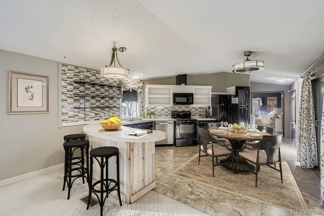 a view of a dining room with furniture and chandelier