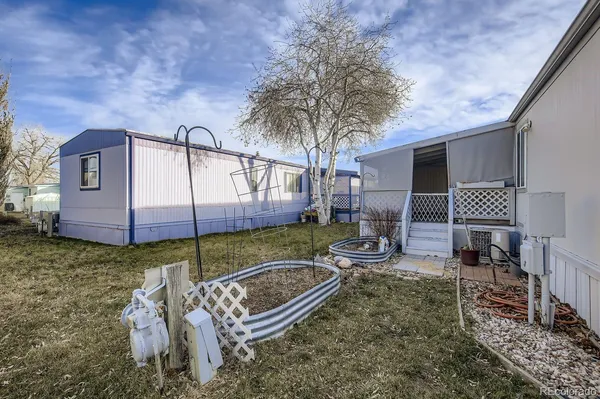 a backyard of a house with barbeque oven table and chairs