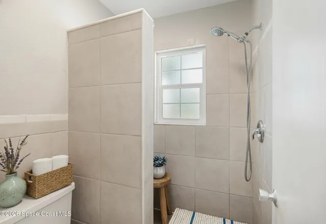 a bathroom with a bathtub and shower