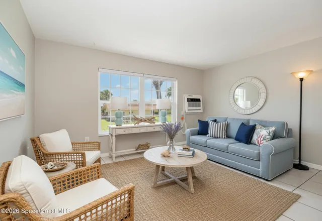 a living room with furniture a rug and a table