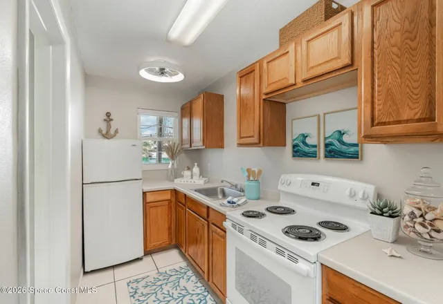 a white refrigerator freezer sitting inside of a kitchen