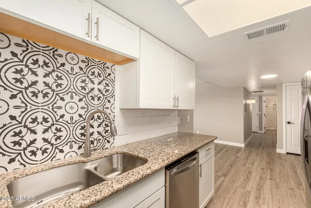 a kitchen with granite countertop a sink and a granite top