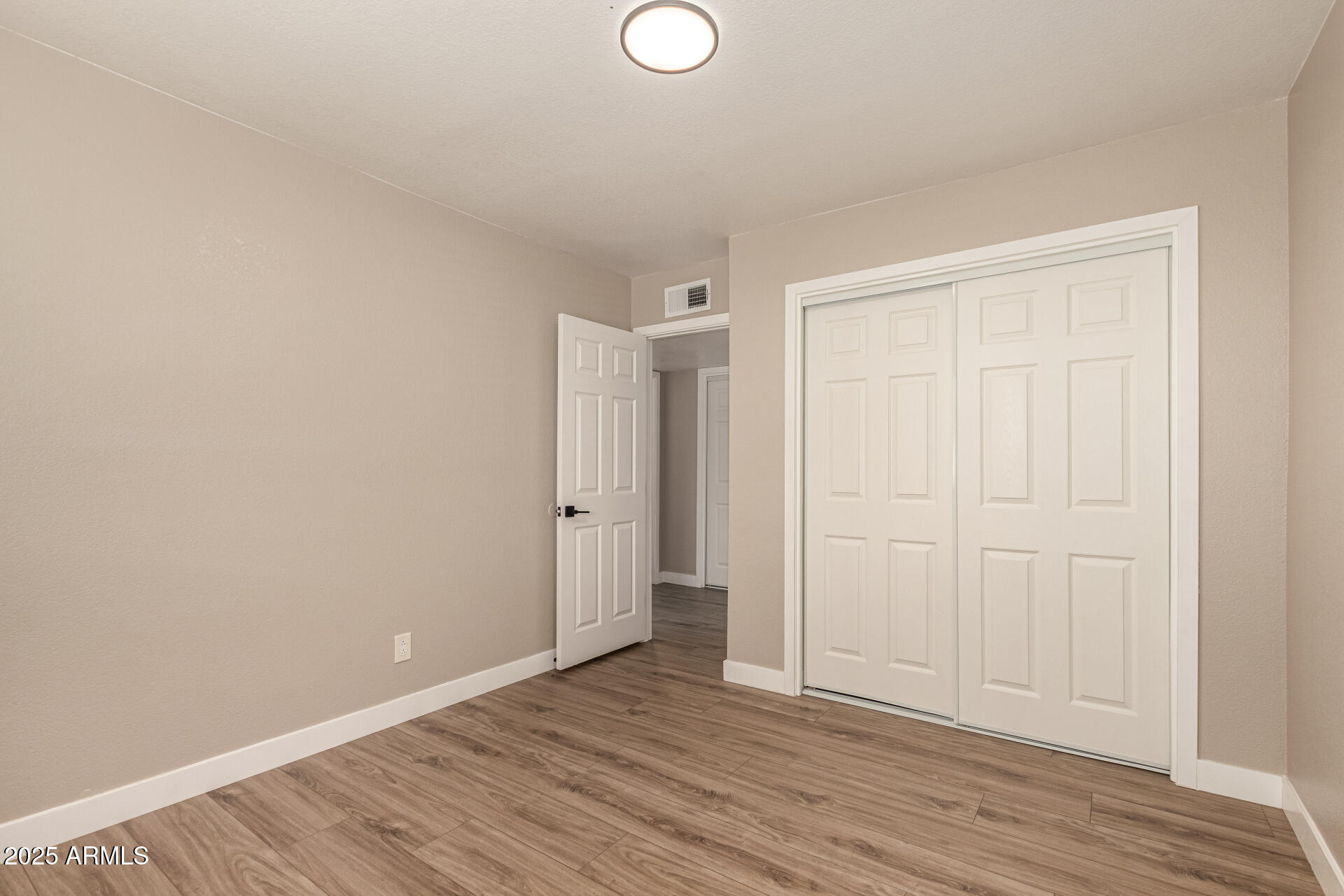2633 West Ocotillo Road, Unit 3 Phoenix, AZ 85017 - Photo 17 of 27 a view of an empty room with wooden floor