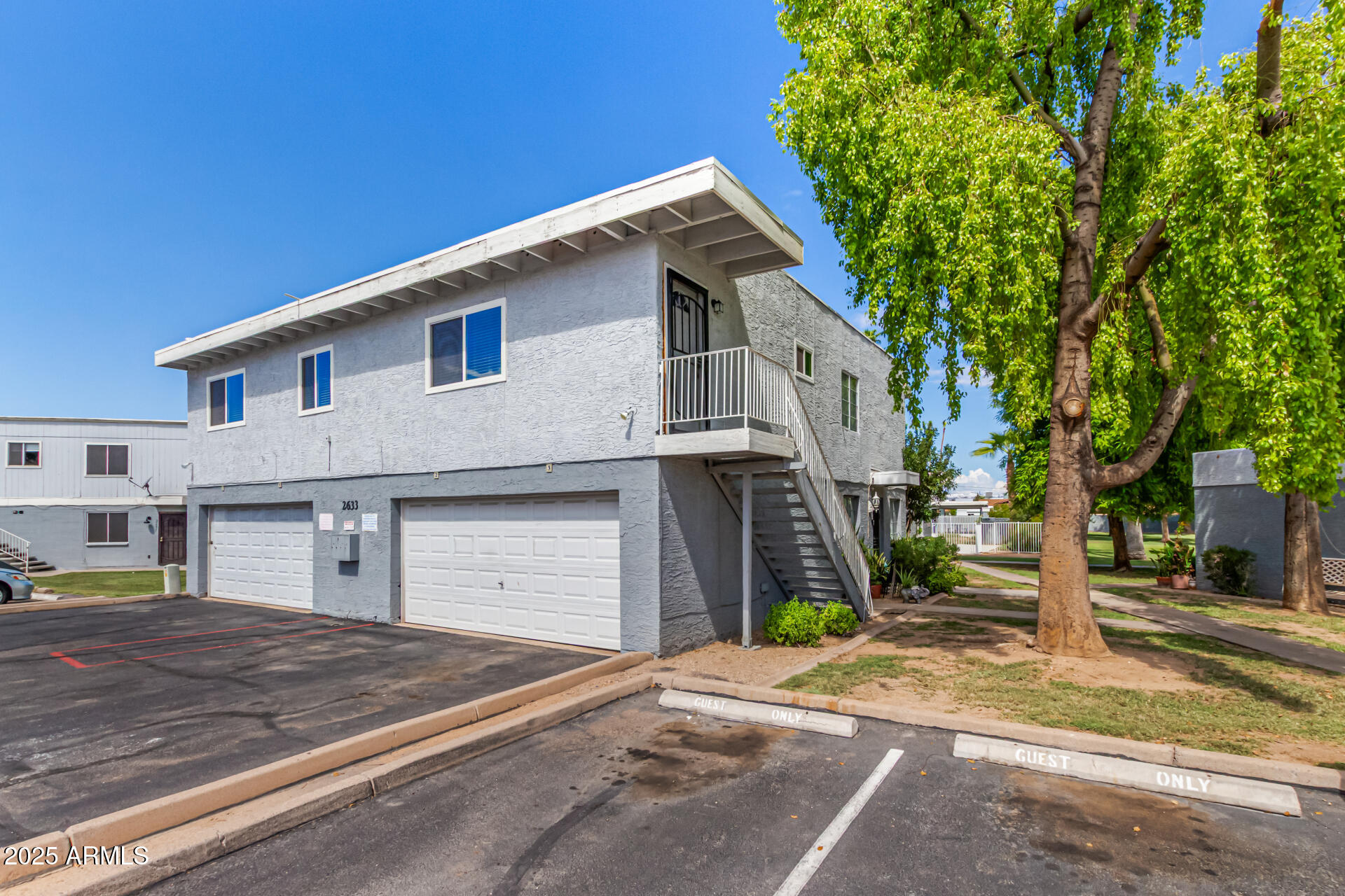 2633 West Ocotillo Road, Unit 3 Phoenix, AZ 85017 - Photo 2 of 27 a front view of a house with a yard and garage