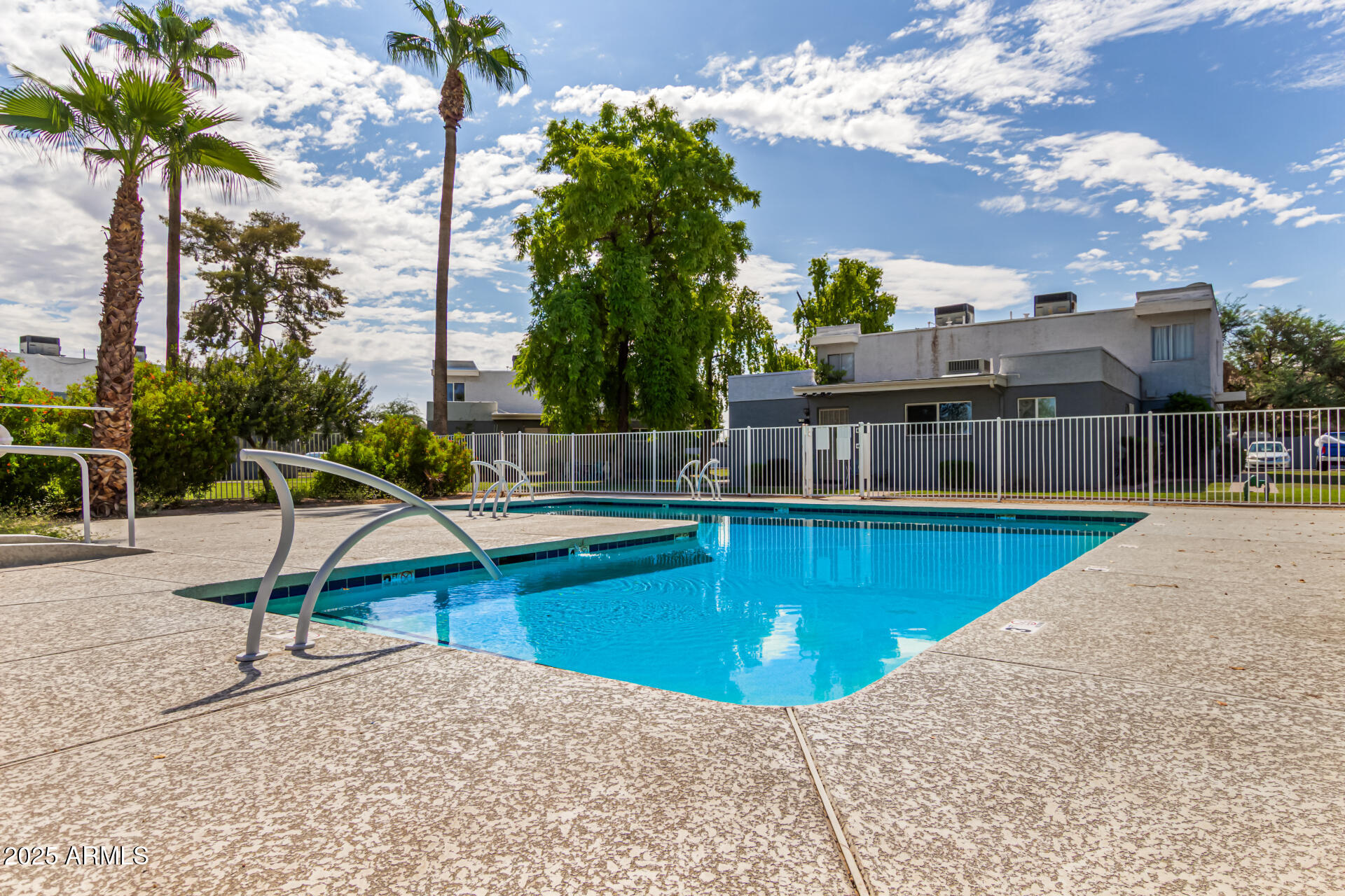 2633 West Ocotillo Road, Unit 3 Phoenix, AZ 85017 - Photo 23 of 27 a view of a swimming pool with a lounge chair