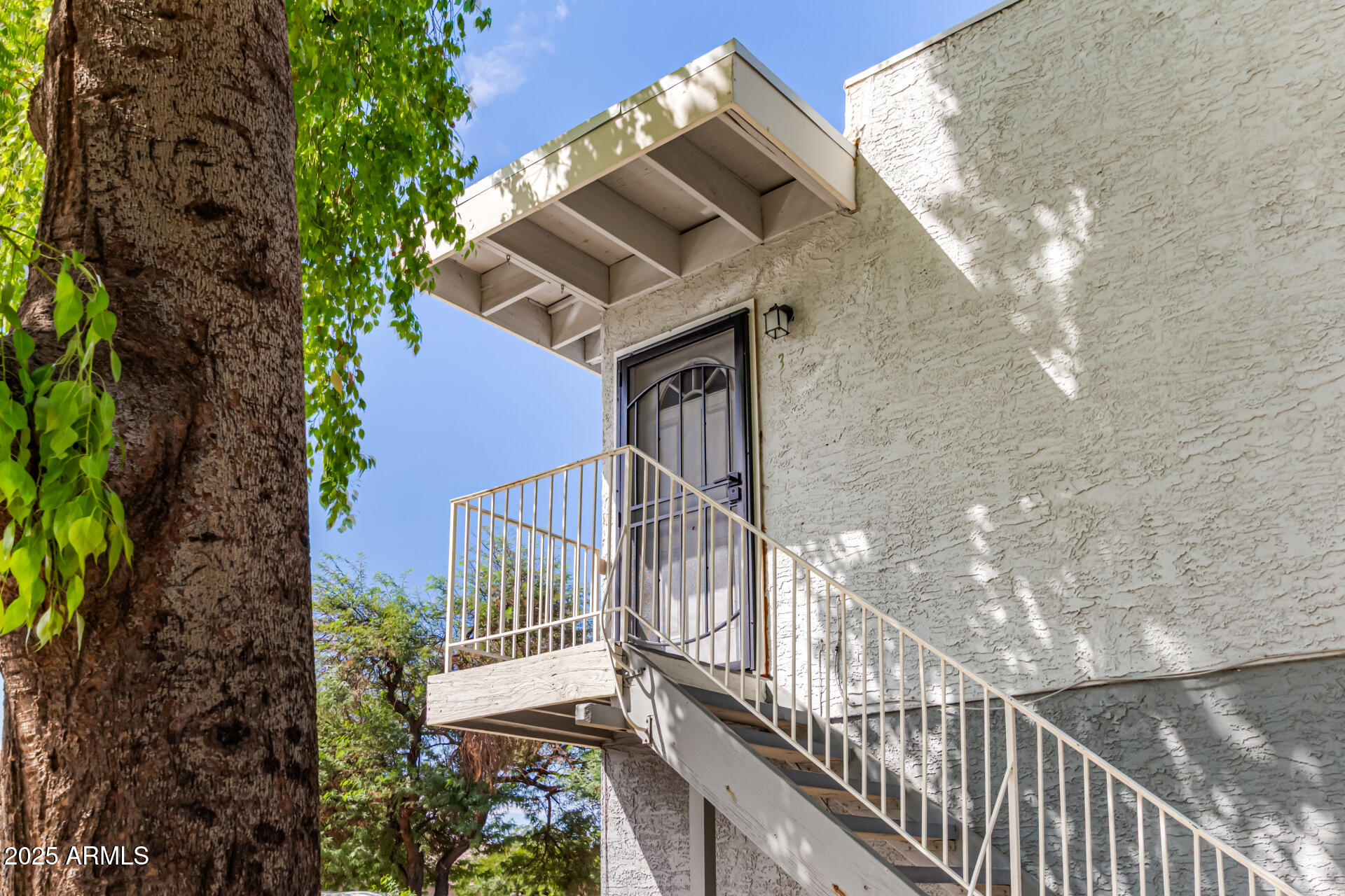 2633 West Ocotillo Road, Unit 3 Phoenix, AZ 85017 - Photo 3 of 27 a balcony of a house with wooden floor