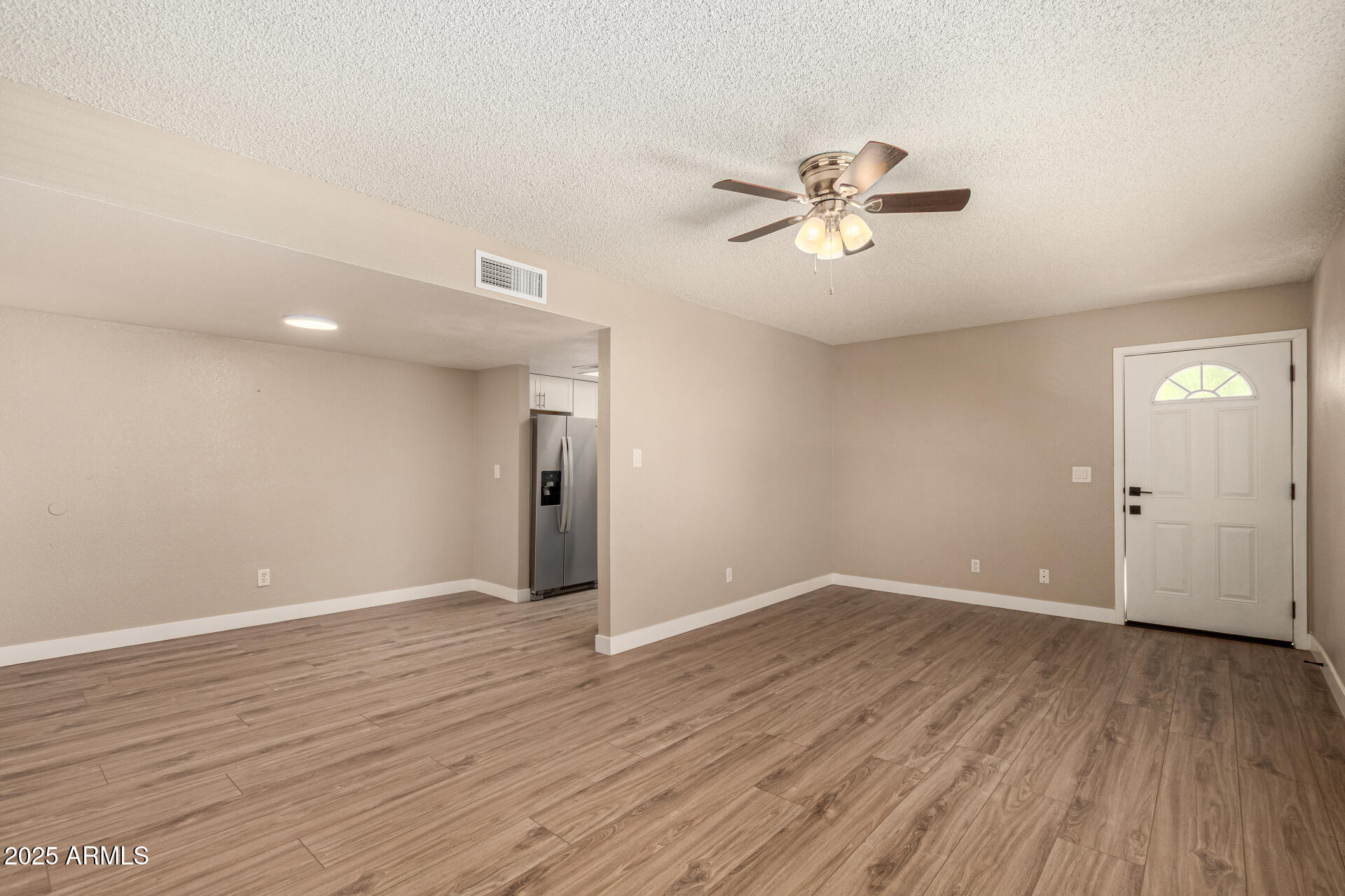 2633 West Ocotillo Road, Unit 3 Phoenix, AZ 85017 - Photo 6 of 27 wooden floor in an empty room with a window