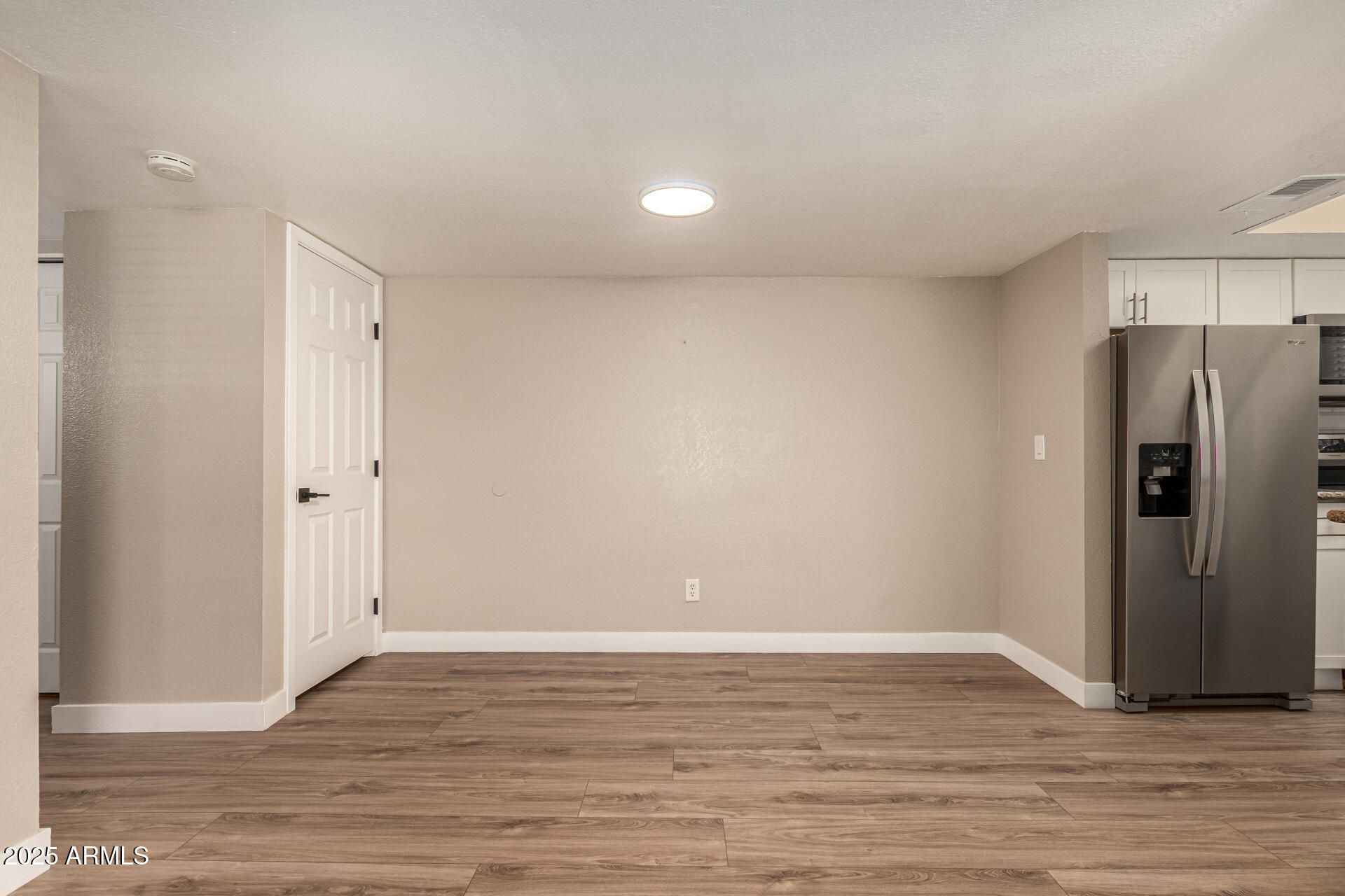 2633 West Ocotillo Road, Unit 3 Phoenix, AZ 85017 - Photo 7 of 27 a view of an empty room with wooden floor and a window