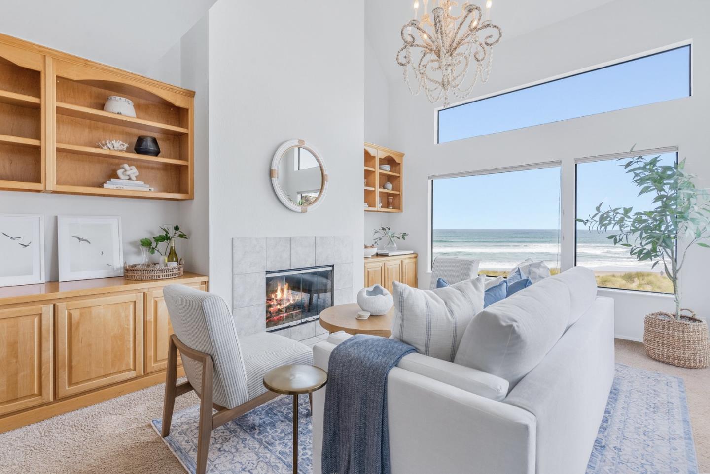 a living room with furniture a fireplace and a large window