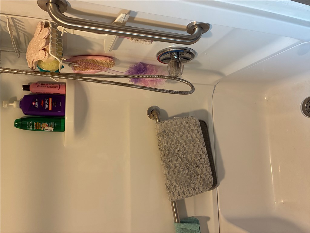 1743 Welcome Road Williamston, SC 29697 - Photo 11 of 11 A classic bathtub and shower combination includes durable white surrounds and integrated safety grab bars.