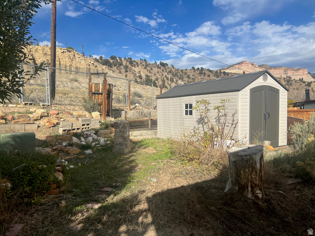 819 Castle Gate Circle Helper, UT 84526 - Photo 31 of 36 View of yard with a storage unit and a mountain view