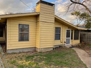 7001 Twin Crest Drive Austin, TX 78752 - Photo 11 of 14 a front view of a house with garden