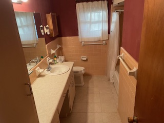 7001 Twin Crest Drive Austin, TX 78752 - Photo 6 of 14 a bathroom with a sink mirror and vanity