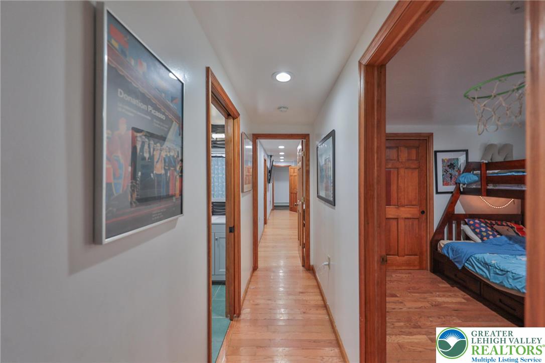 257 Hoffman Road Wind Gap, PA 18091 - Photo 11 of 52 a view of a hallway to a livingroom and a hall with wooden floor