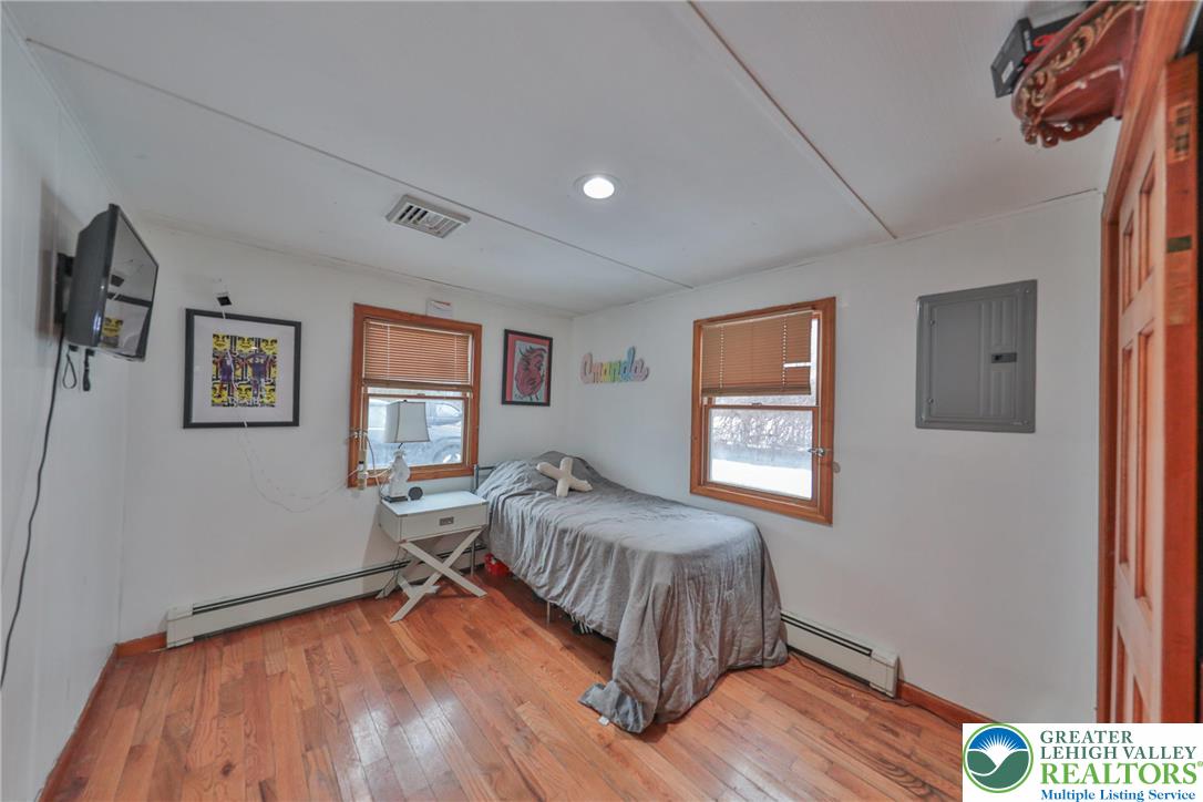 257 Hoffman Road Wind Gap, PA 18091 - Photo 16 of 52 a bedroom with a bed and wooden floor