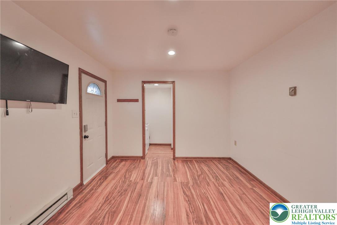 257 Hoffman Road Wind Gap, PA 18091 - Photo 41 of 52 a view of an empty room with wooden floor and a flat screen tv