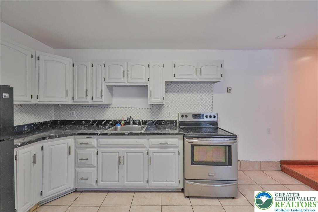 257 Hoffman Road Wind Gap, PA 18091 - Photo 45 of 52 a kitchen with white cabinets and appliances