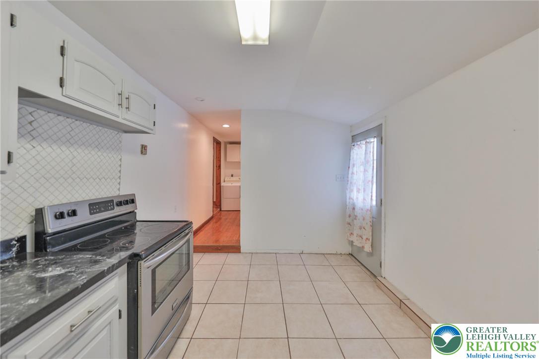 257 Hoffman Road Wind Gap, PA 18091 - Photo 46 of 52 a kitchen with granite countertop a stove a sink and a refrigerator