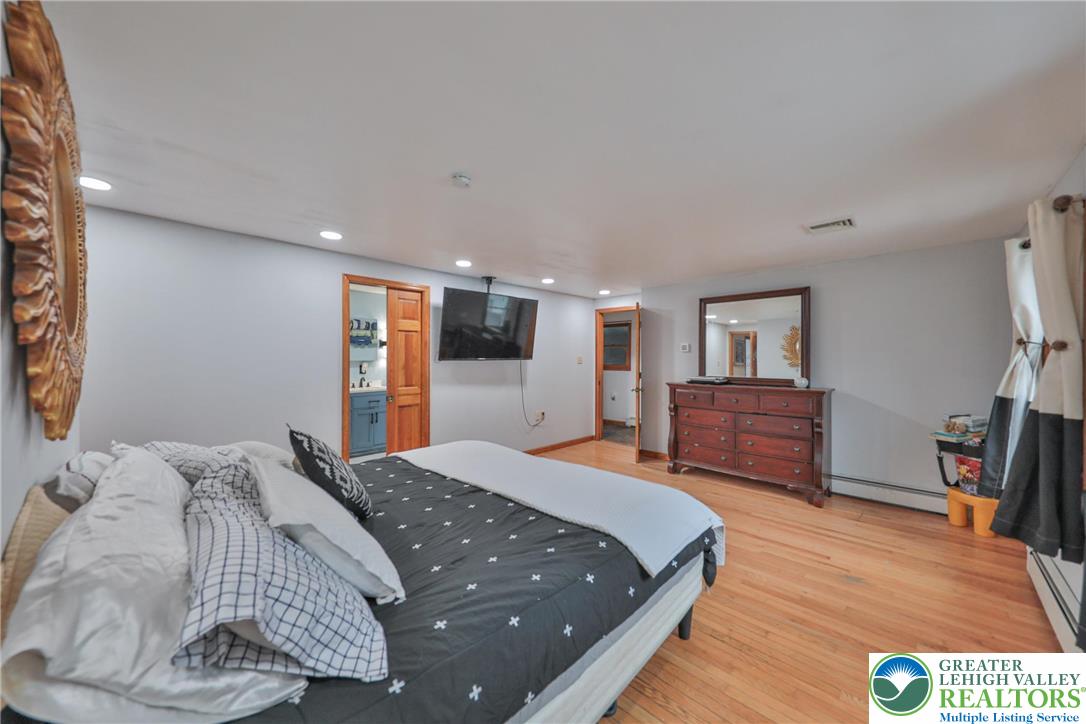 257 Hoffman Road Wind Gap, PA 18091 - Photo 6 of 52 a bedroom with a large bed and a flat screen tv