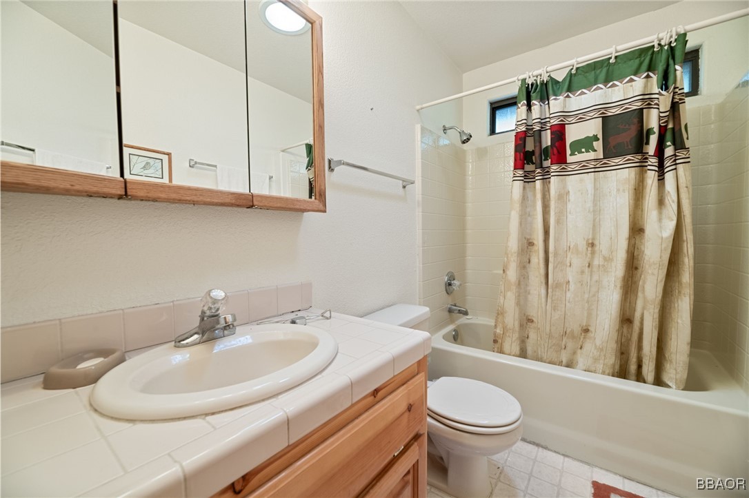 1464 Rockspray Drive Big Bear Lake, CA 92315 - Photo 12 of 26 a bathroom with a sink a toilet and shower