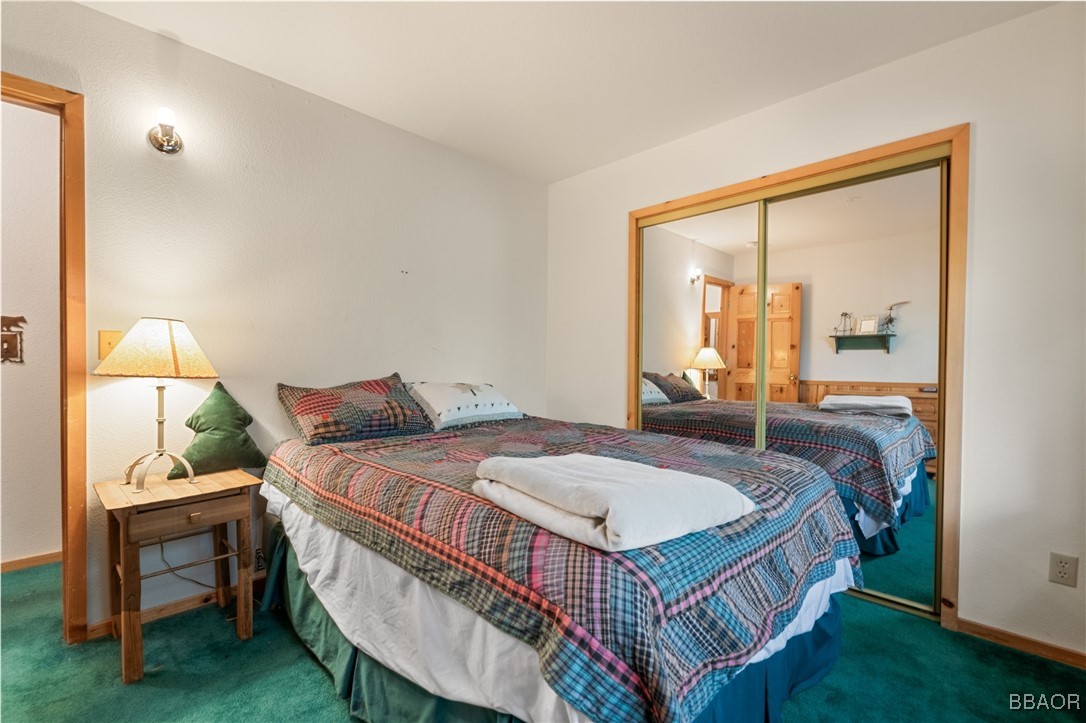 1464 Rockspray Drive Big Bear Lake, CA 92315 - Photo 14 of 26 a bed sitting in a bedroom next to a window