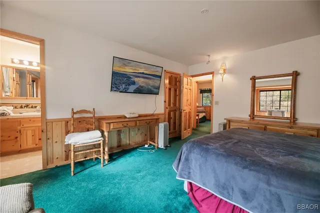 a living room with a bed furniture and a window