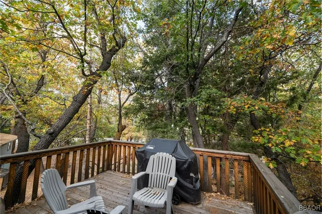a view of roof deck with chairs and wooden fence
