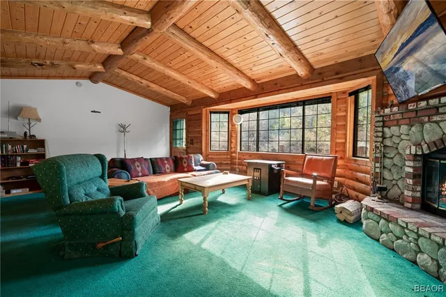a living room with furniture and a floor to ceiling window