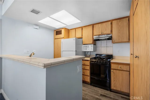 a kitchen with stainless steel appliances granite countertop a stove and a refrigerator