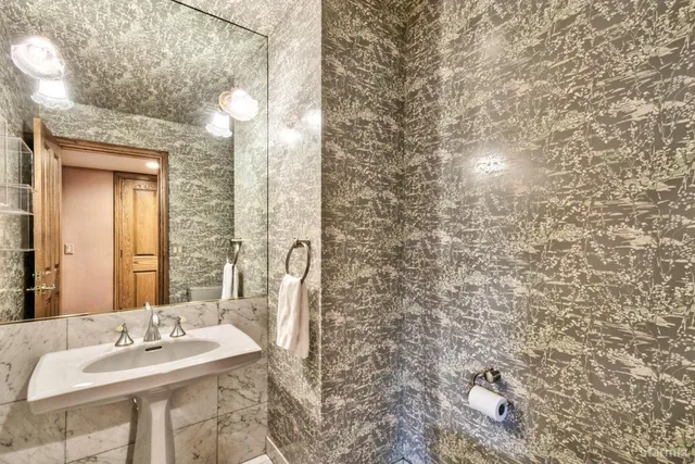 a bedroom with furniture and a large window