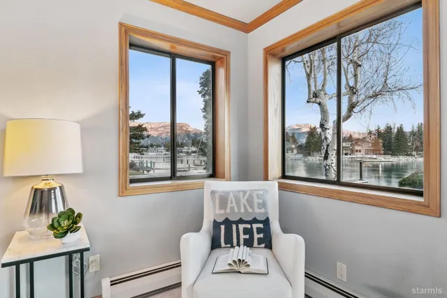 a spacious bedroom with a bed a couch and a large window