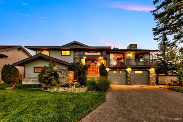an aerial view of a house with swimming pool and lake view