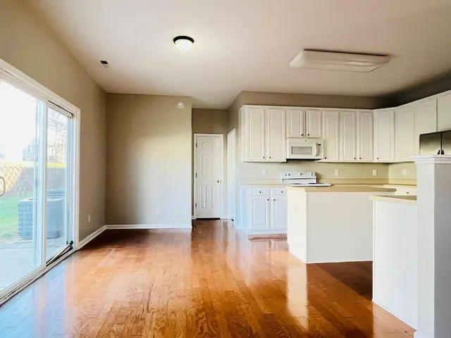a view of a kitchen with wooden floor