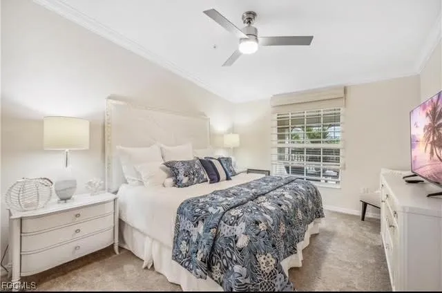 a bed room with a bed a flat screen tv and a window