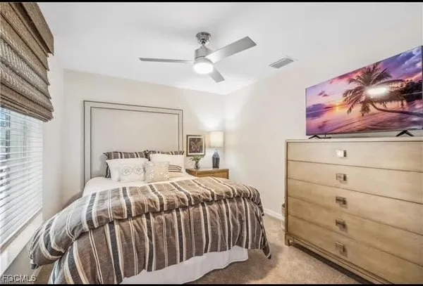 a bedroom with a bed and a painting on the wall