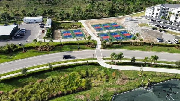 a aerial view of a multi story residential apartment building with yard and outdoor seating