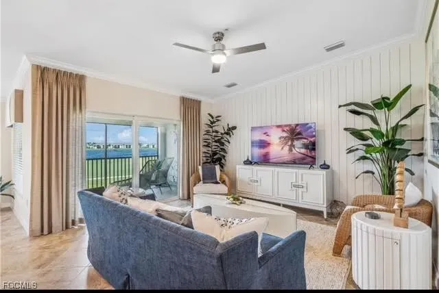 a living room with furniture potted plant and a large window