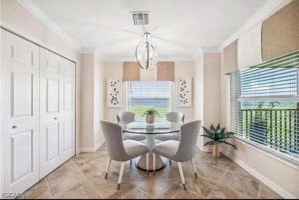 a dining room with furniture a chandelier and wooden floor