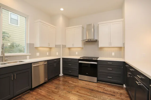 a kitchen with stainless steel appliances granite countertop a stove and a sink