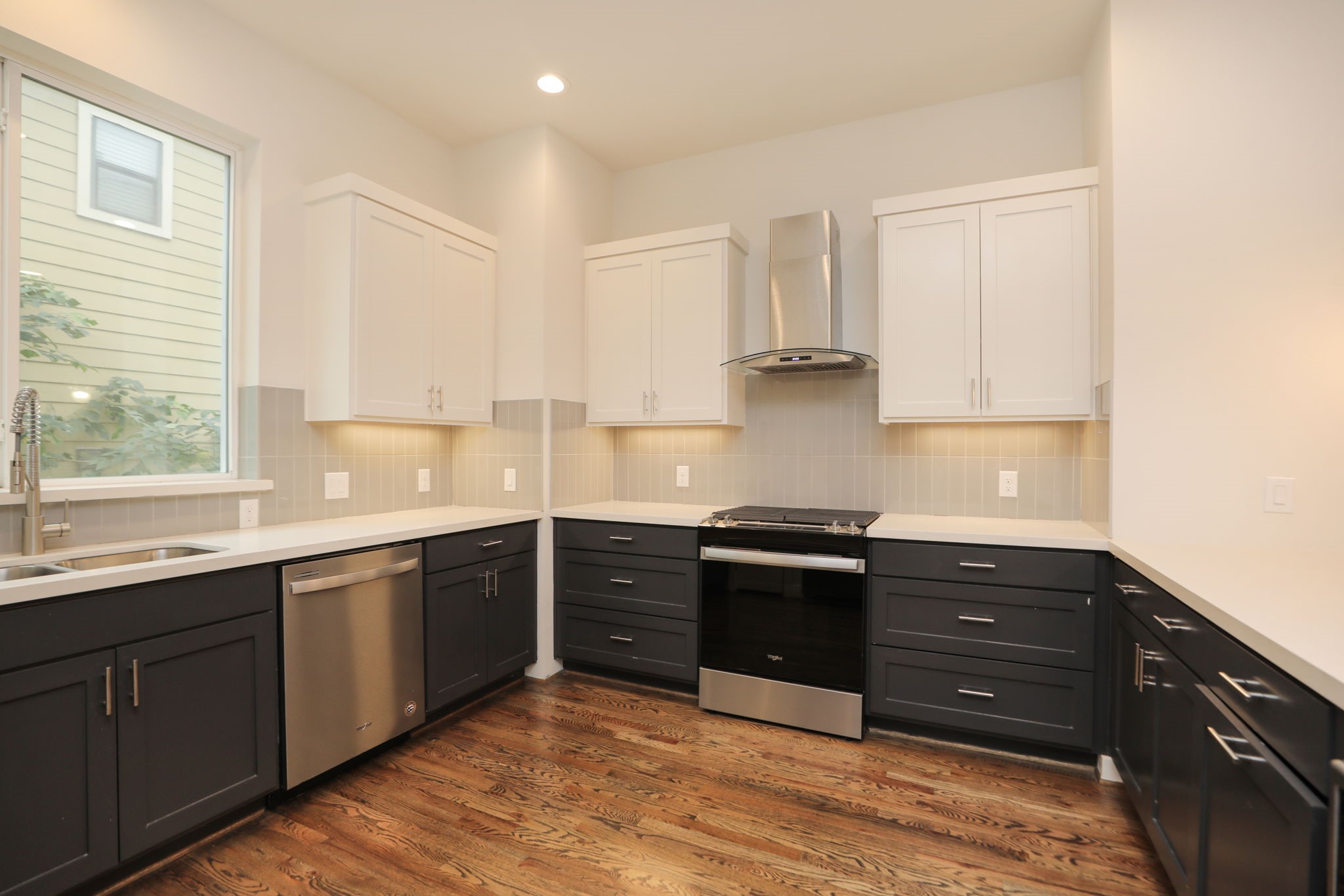 1537 West 24th Street, Unit C Houston, TX 77008 - Photo 11 of 34 a kitchen with stainless steel appliances granite countertop a stove and a sink