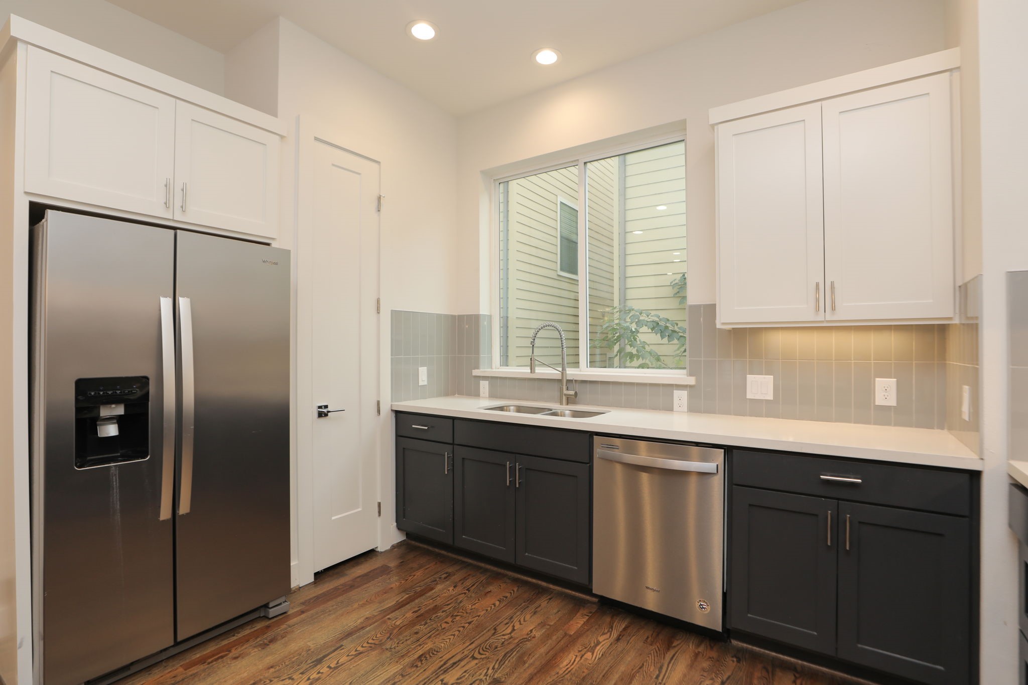 1537 West 24th Street, Unit C Houston, TX 77008 - Photo 12 of 34 a kitchen with stainless steel appliances granite countertop a refrigerator and a sink
