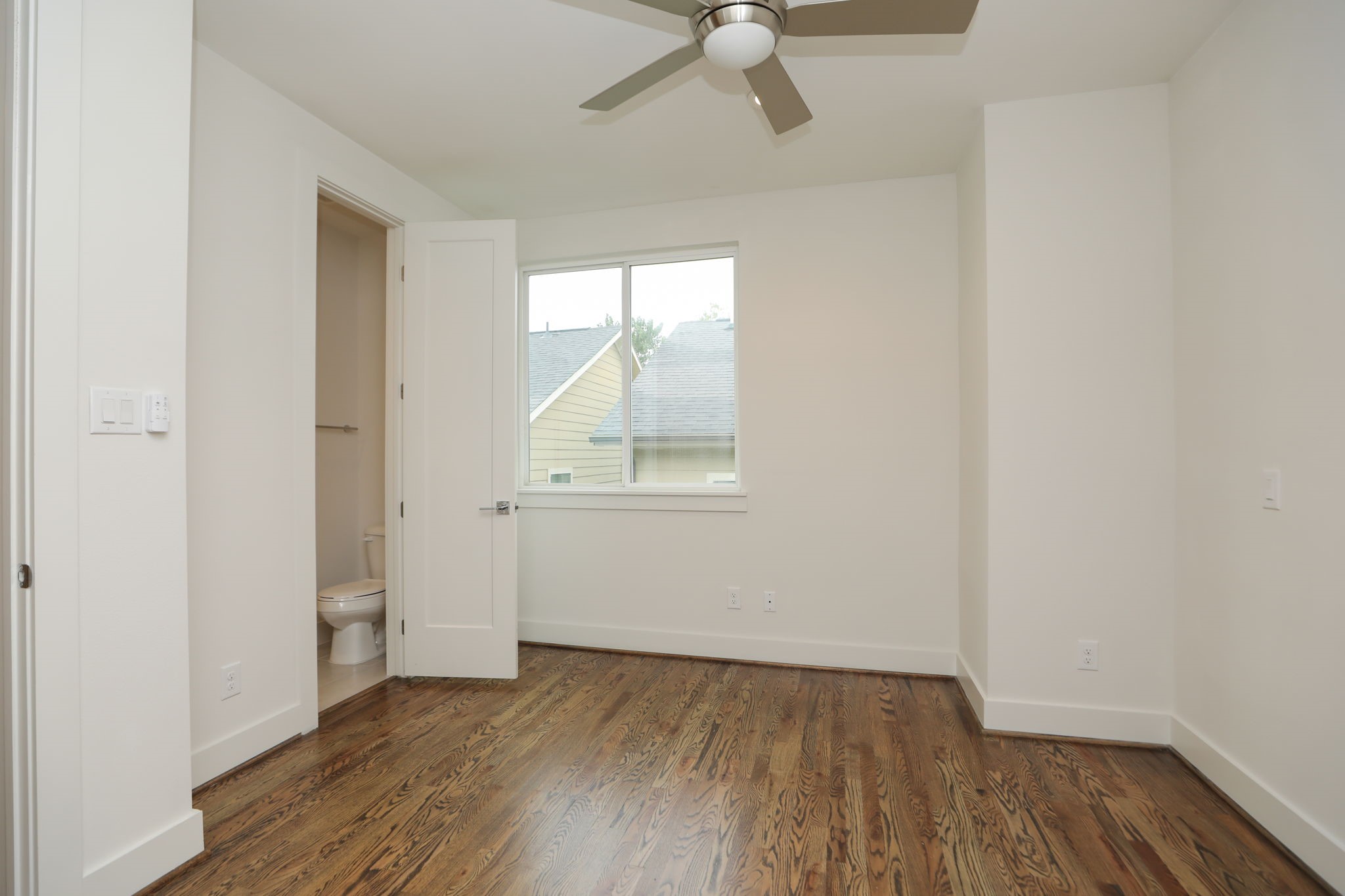 1537 West 24th Street, Unit C Houston, TX 77008 - Photo 20 of 34 an empty room with wooden floor fan and windows