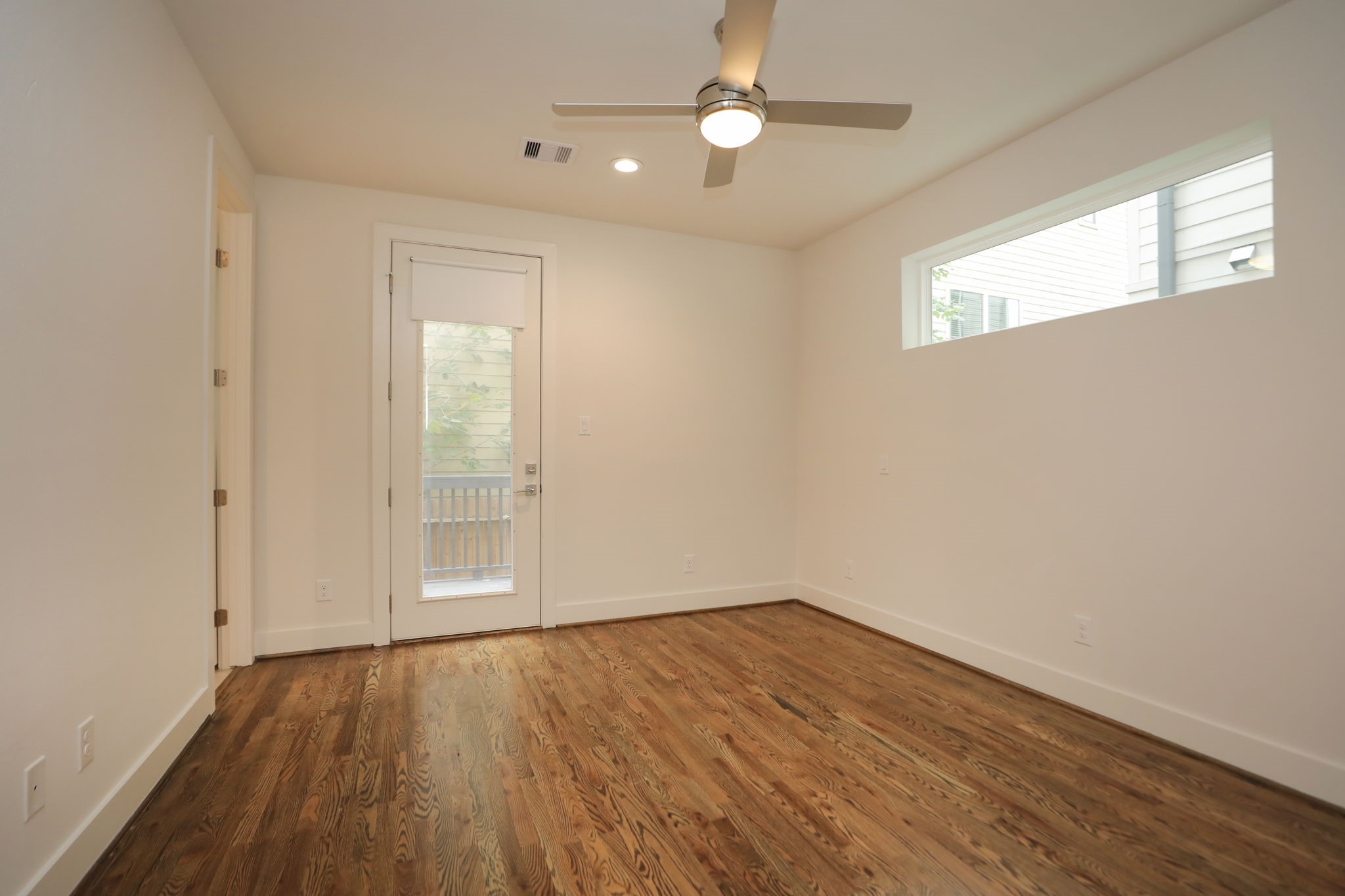 1537 West 24th Street, Unit C Houston, TX 77008 - Photo 6 of 34 wooden floor in an empty room with a window