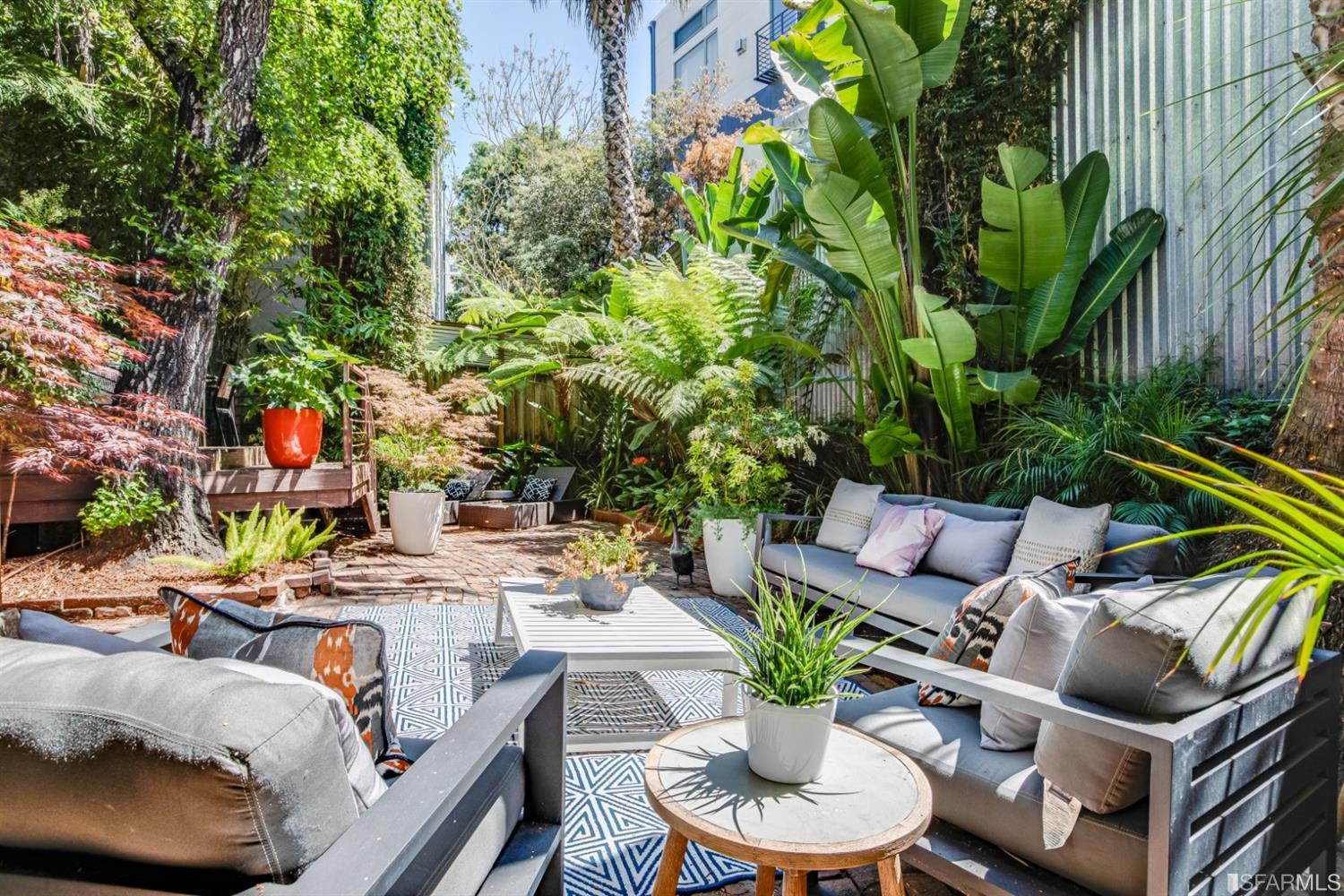275 Shipley San Francisco, CA 94103 - Photo 27 of 95 a view of a patio with couches table and chairs potted plants and palm tree