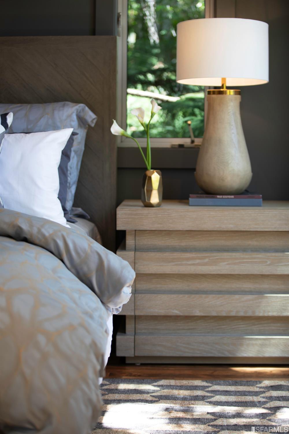 275 Shipley San Francisco, CA 94103 - Photo 53 of 95 a bed sitting in a bedroom next to a window with potted plants