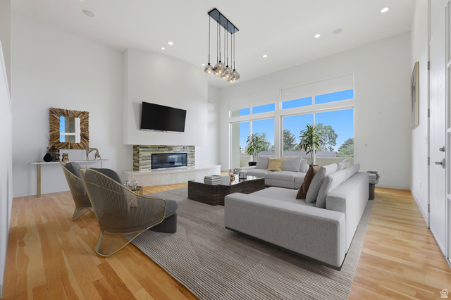 1389 Millbrook Way Bountiful, UT 84010 - Photo 14 of 74 Spacious living area featuring high ceilings, light wood-finish flooring, and ample natural light from extensive windows