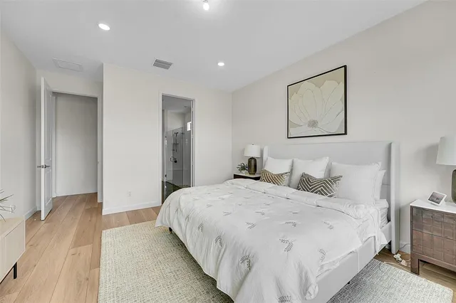 a bedroom with a bed and a painting