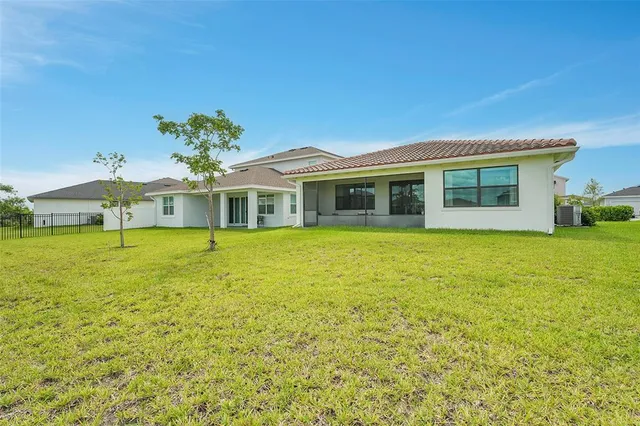 a front view of a house with a garden and yard